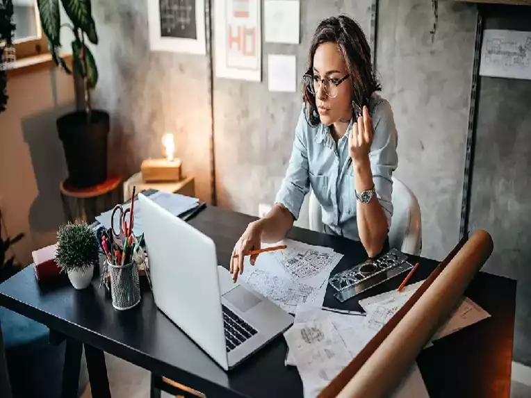 Picture of a female at here work space that is located in her home